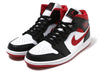 This is the left shoe of Air Jordan 1 Mid Gym Red Black